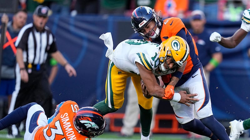 Green Bay Packers quarterback Jordan Love (10) runs against Denver Broncos safety Justin...