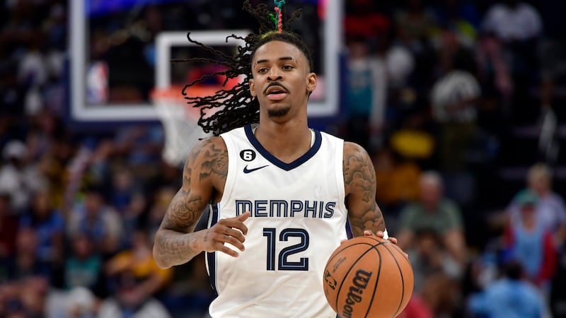 Memphis Grizzlies guard Ja Morant (12) brings the ball up court in the second half of an NBA...