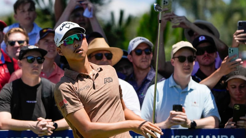 Australia's Min Woo Lee hits off the third tee during the final round of the Australian Open...