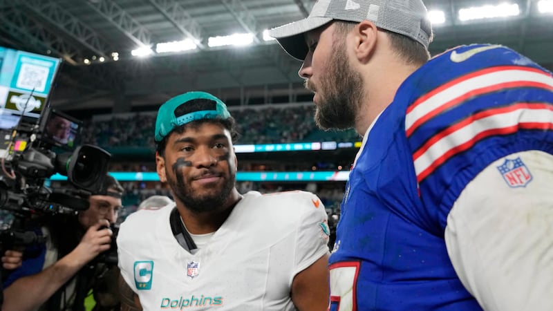 Miami Dolphins quarterback Tua Tagovailoa and Buffalo Bills quarterback Josh Allen talk at the...