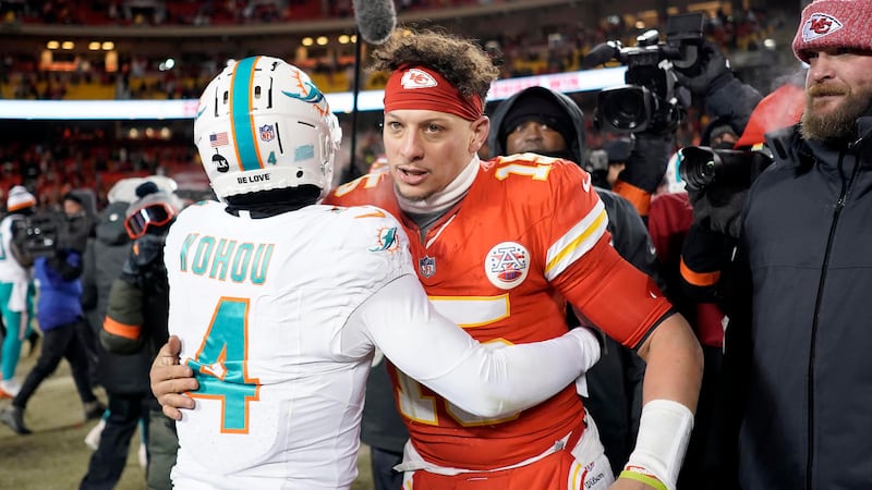 Miami Dolphins cornerback Kader Kohou (4) hugs Kansas City Chiefs quarterback Patrick Mahomes...