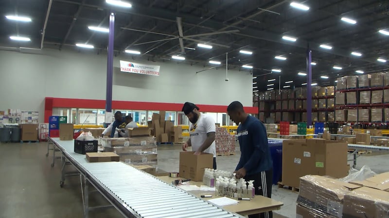 Memphis Showboats help pack boxes at Mid-South Food Bank