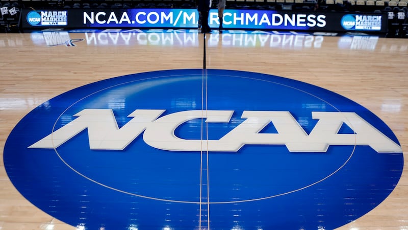 FILE - In this March 18, 2015, file photo, the NCAA logo is displayed at center court at The...