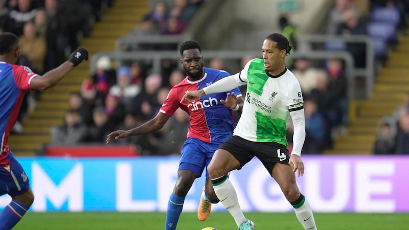 Liverpool's Virgil van Dijk, right, challenges for the ball with Crystal Palace's Odsonne...