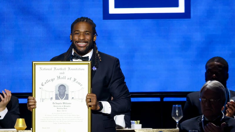 Former Memphis running back DeAngelo Williams holds up his College Football Hall of Fame Award...