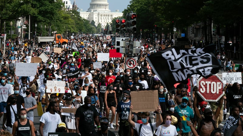 People walk on Pennsylvania Avenue during the March on Washington, Friday Aug. 28, 2020, on...