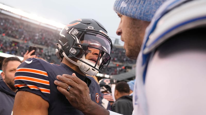 Chicago Bears quarterback Justin Fields, left, and Detroit Lions quarterback Jared Goff talk...
