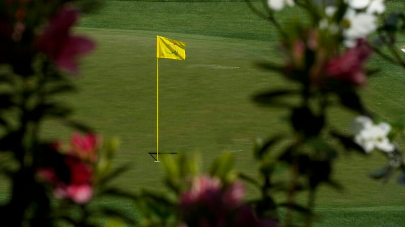 Azaleas frame the flag on the 16th Green during a practice round for the Masters golf...