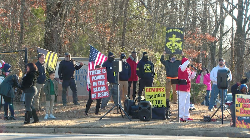 Demonstrators protest the "After School Satan Club," launched by the Satanic Temple, outside...