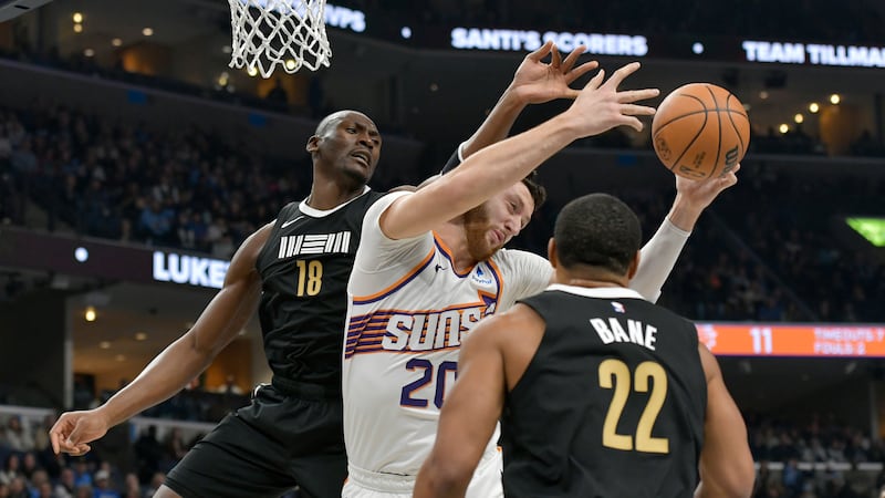 Phoenix Suns center Jusuf Nurkic (20) grabs a rebound between Memphis Grizzlies center Bismack...