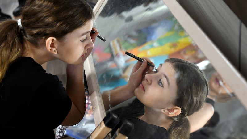 Erica Biggs puts on makeup before performing in “The Bullying Collection” at Wheatland High...