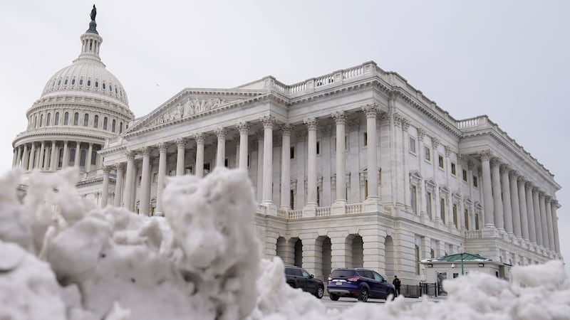 The U.S Capitol is photographed past piles of snow on Thursday, Jan. 18, 2024, in Washington.