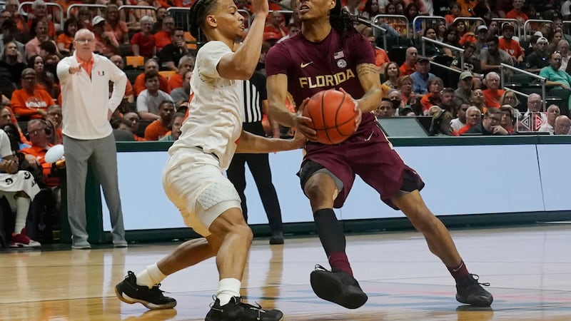 Miami guard Isaiah Wong (2) defends Florida State guard Caleb Mills (4) during the first half...